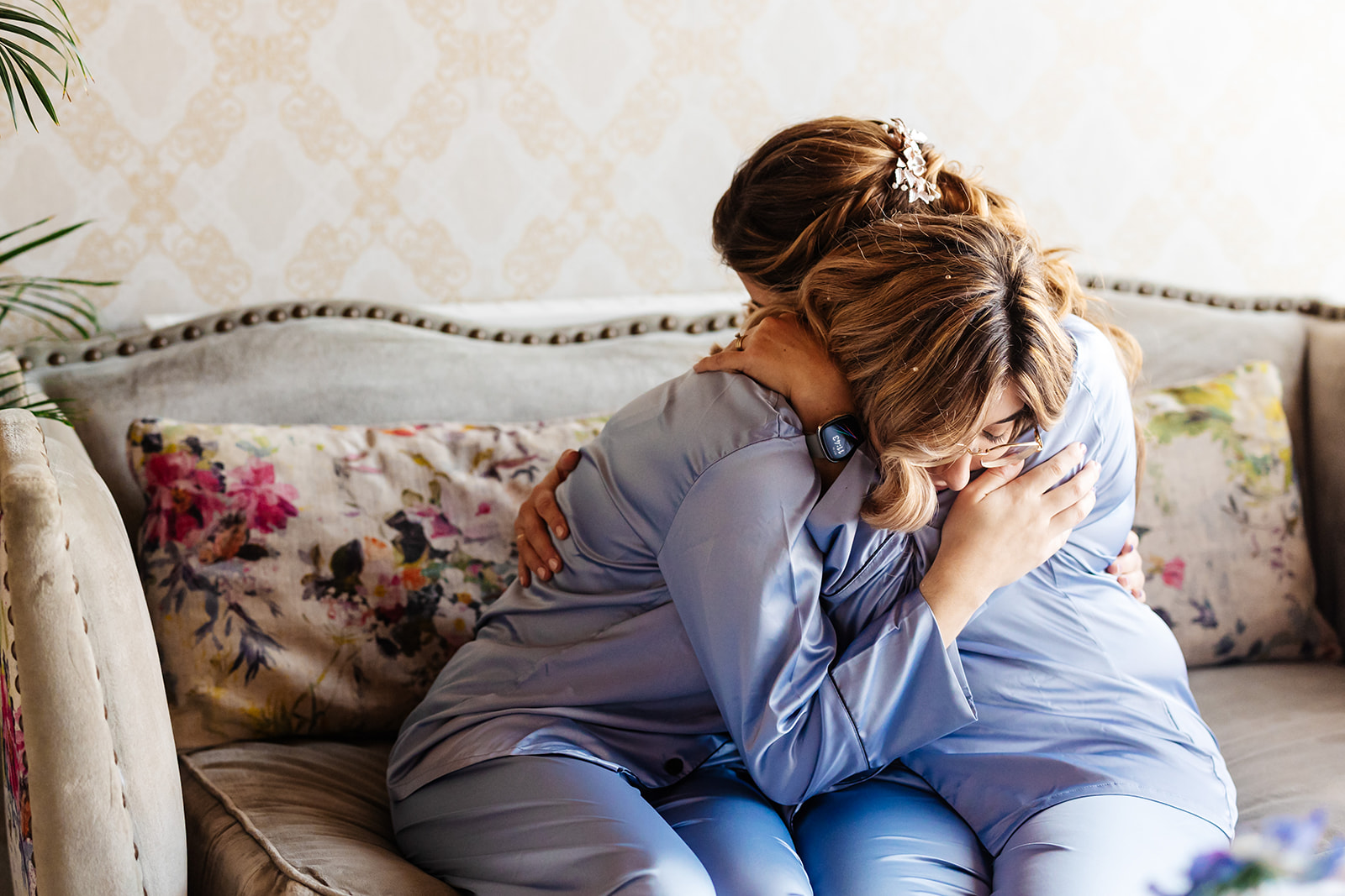 Two ladies cuddling in blue pyjamas sharing a heartfelt moment