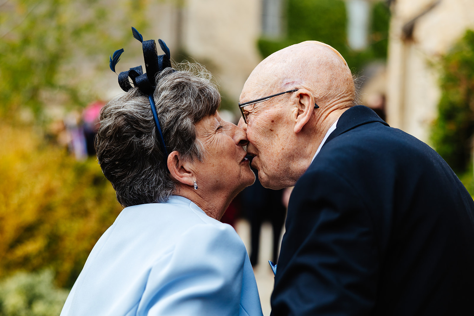 An elderly couple sharing a kiss