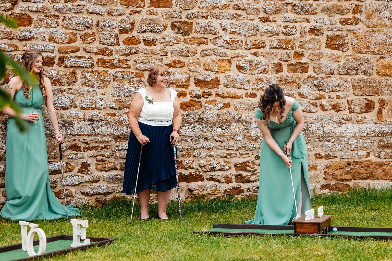 Wedding guests playing mini golf outside