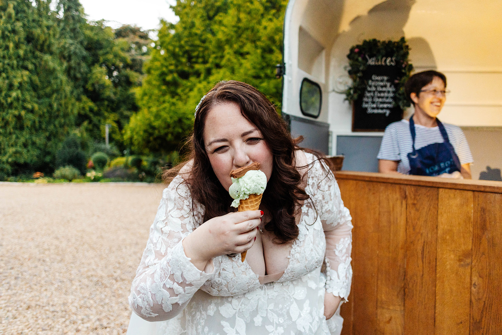 A bride eating an ice cream and smiling