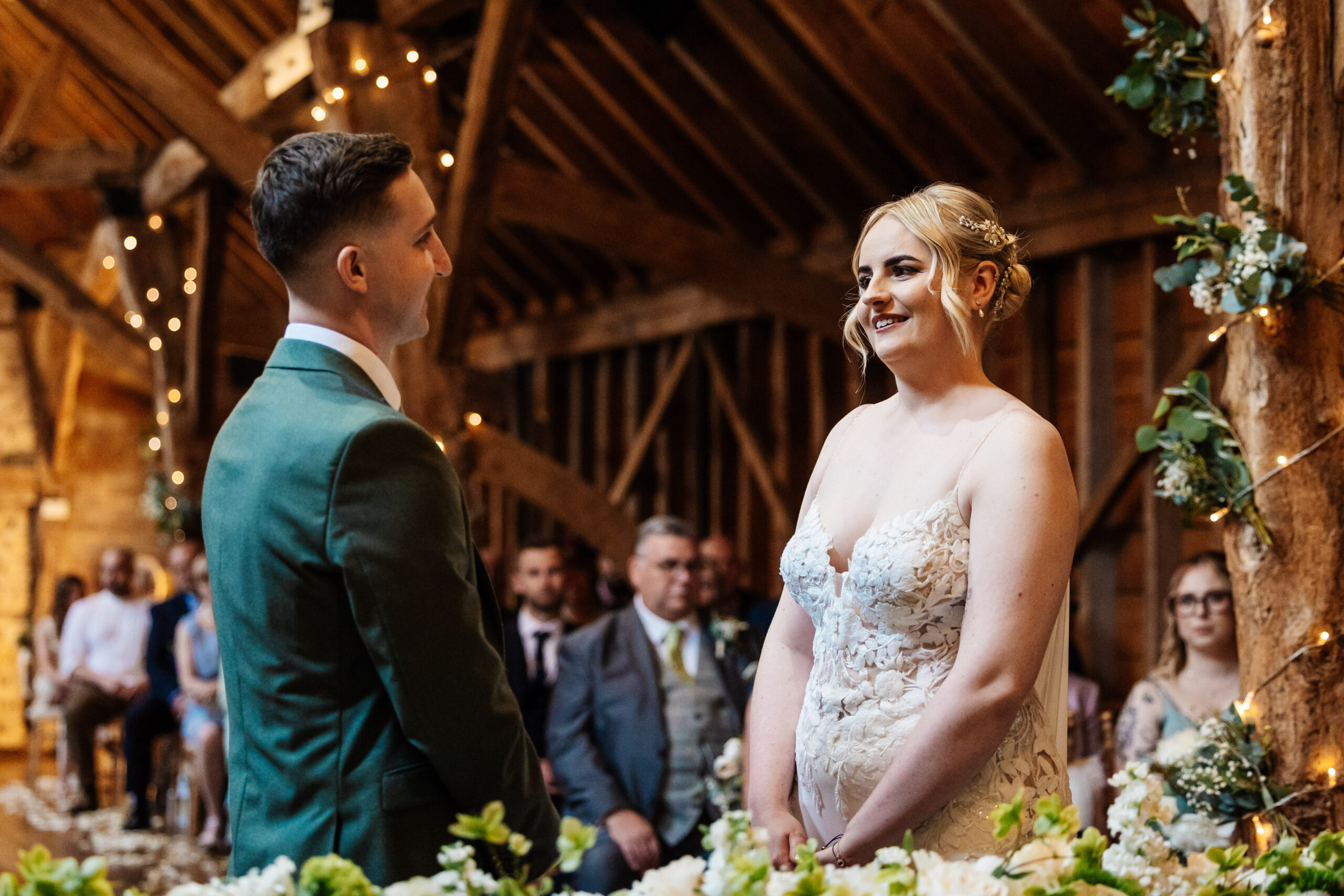 A bride and groom looking at each other at the alter about to get married.