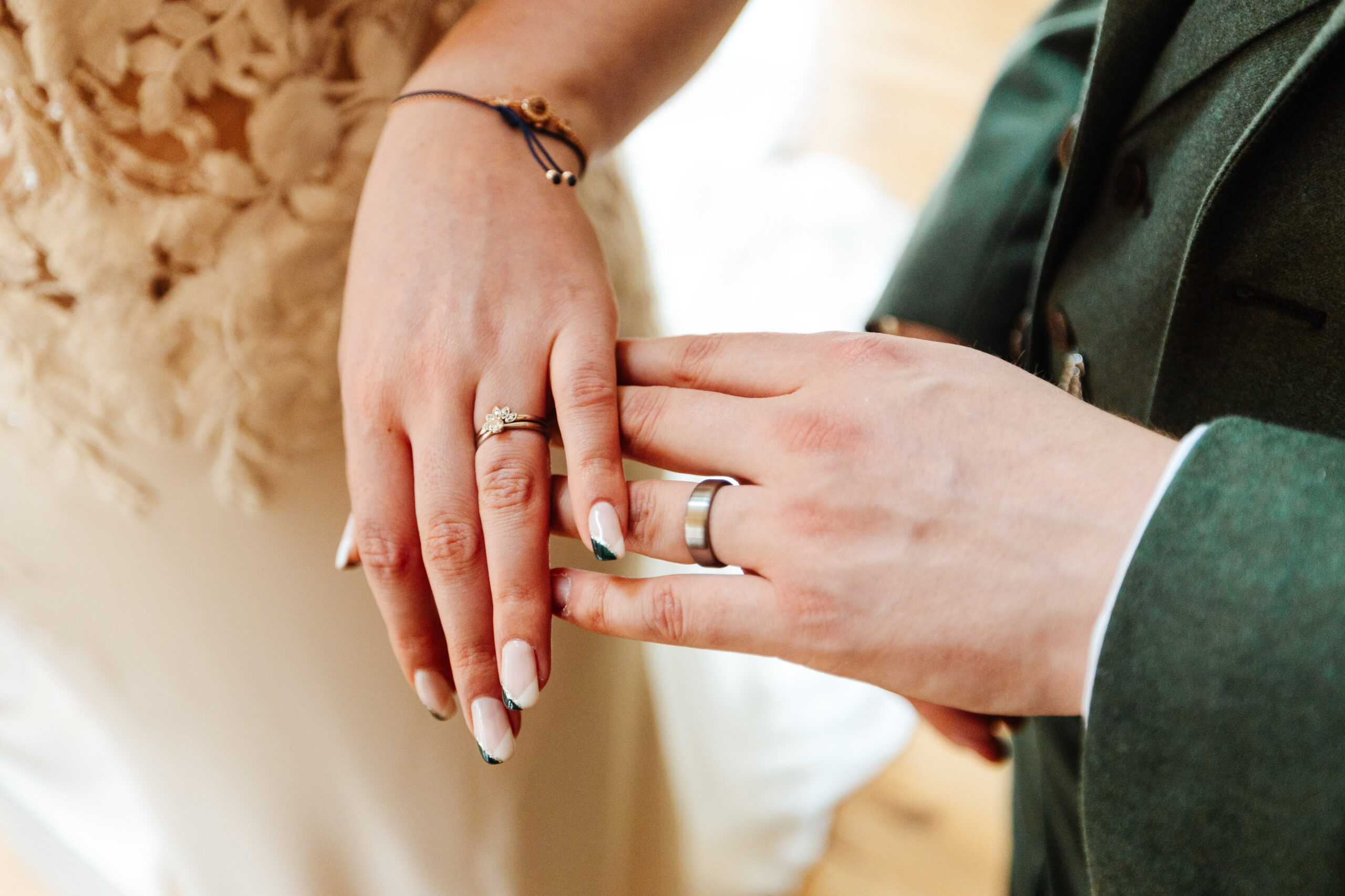 A ladies hand on top of a man's hand. You can see their wedding bands.