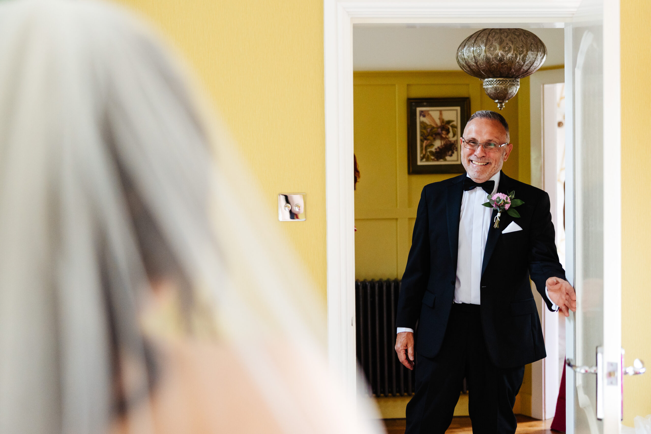 The father of the bride. You can see the bride's veil so the father is looking at his bride. He looks so happy and proud.