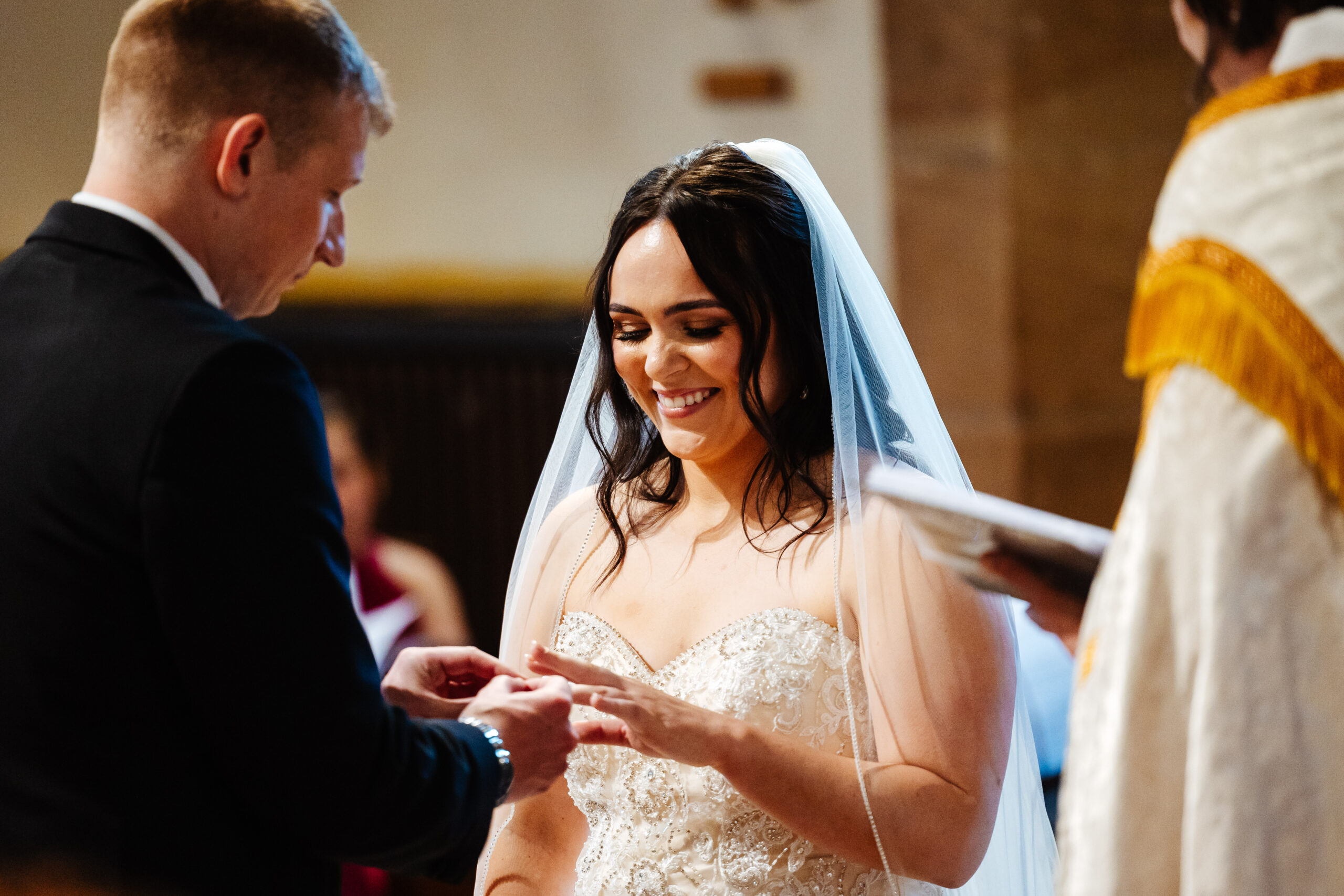 The bride and groom exchanging rings.