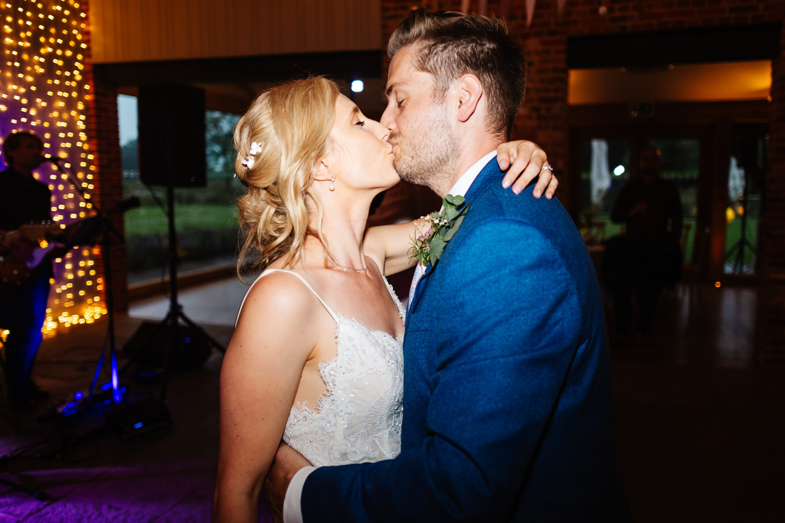 The bride and groom on the dancefloor, kissing.