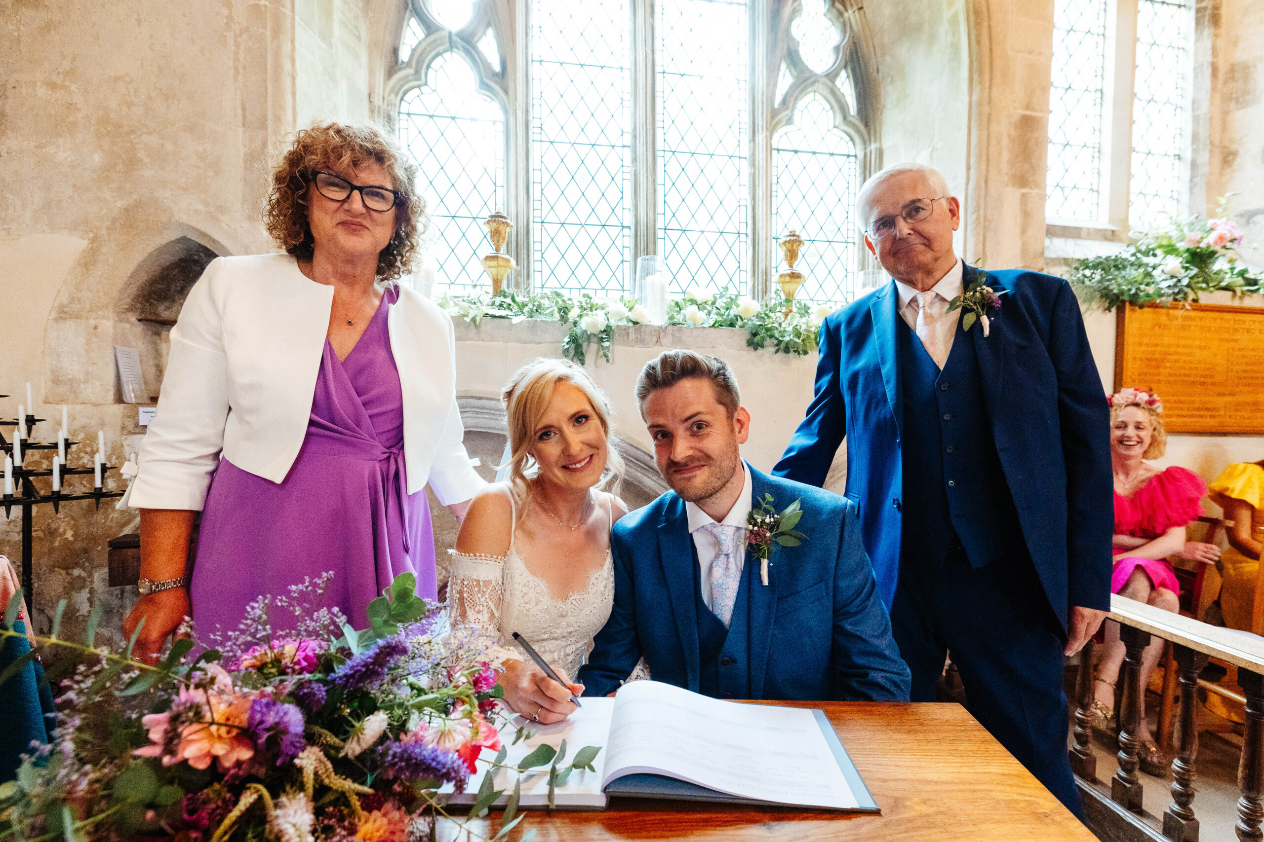 The bride and groom and their witnesses signing their marriage papers.