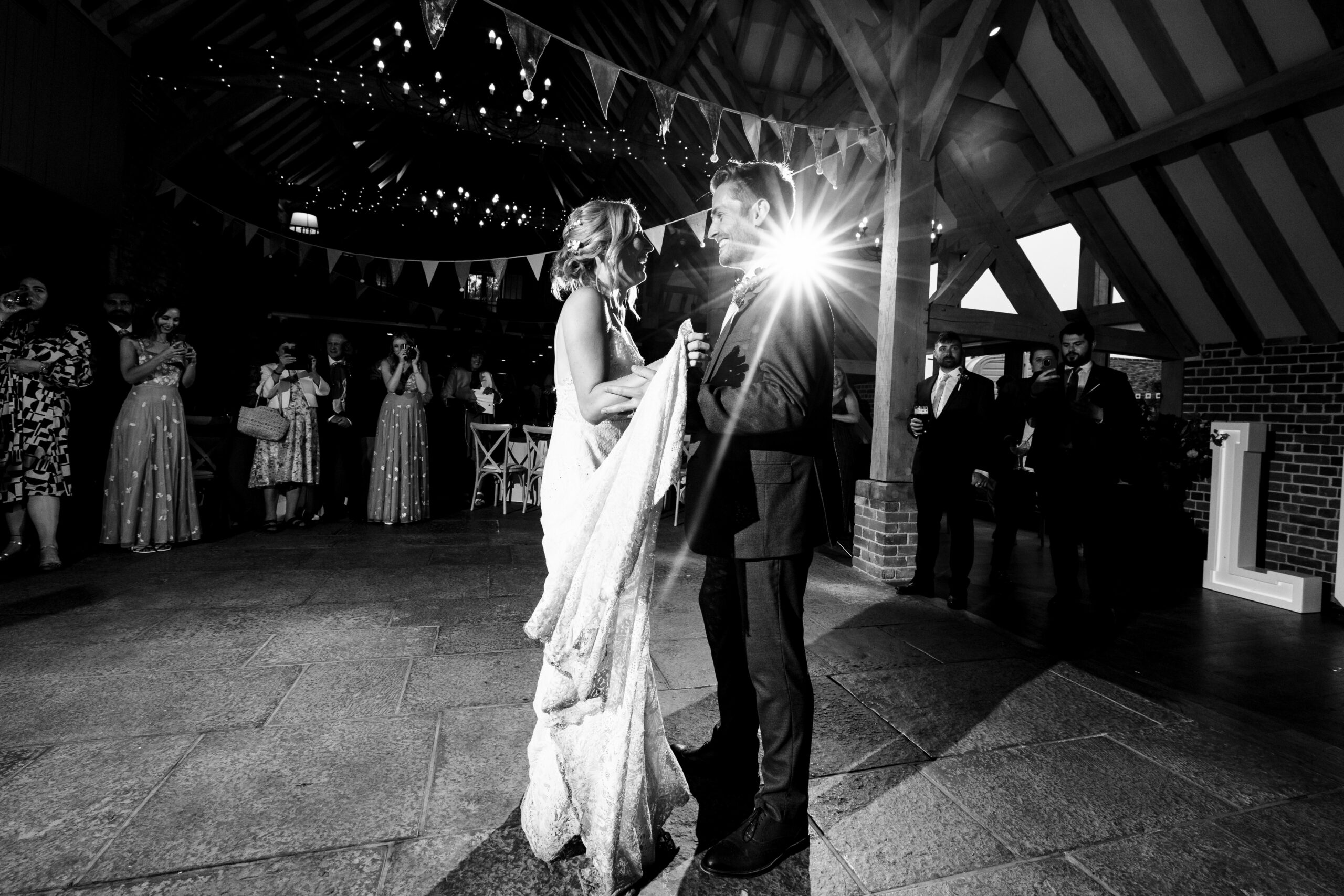 The bride and groom for their first dance. This is a black and white image.