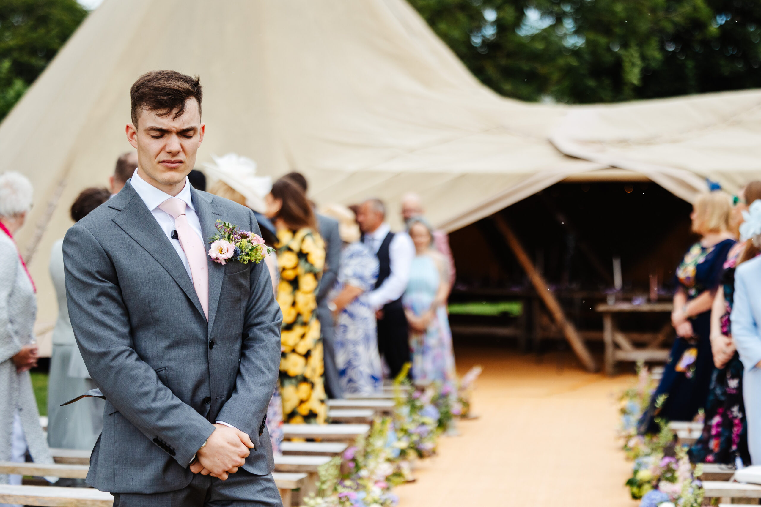 A photo of the groom with his eyes closed in emotion, just before his wedding day.