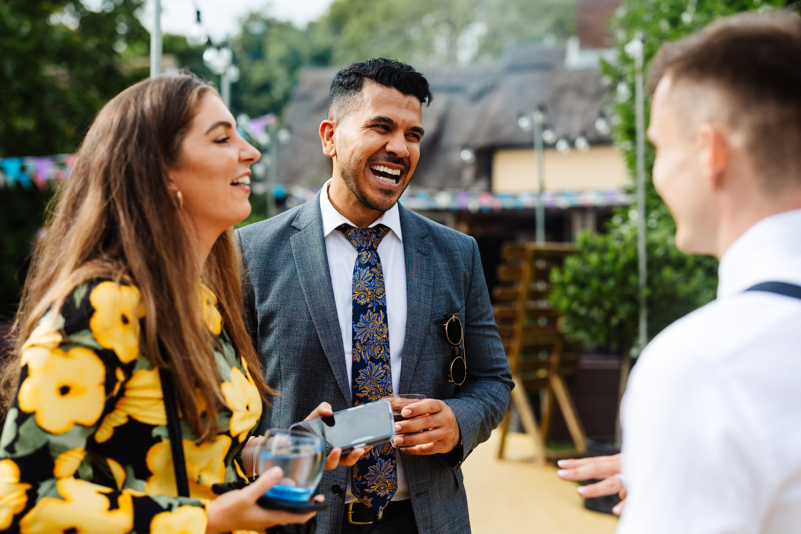 Guests enjoying themselves and laughing outdoors.