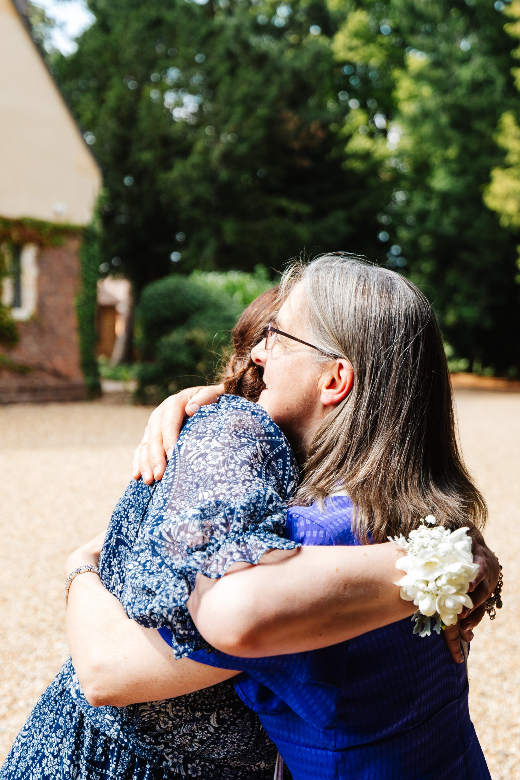 Two guests hugging in an intimate moment before the wedding.