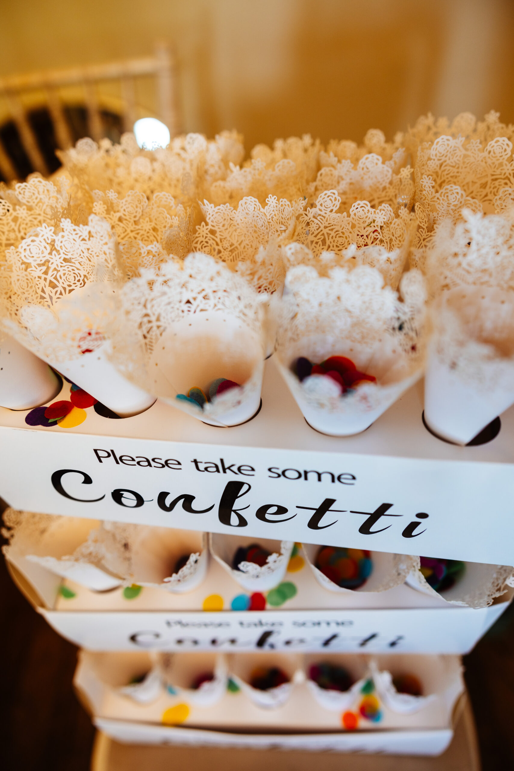 Little pots of conferti ready for later! They are in laced cones and the confetti is little, bright coloured circles.