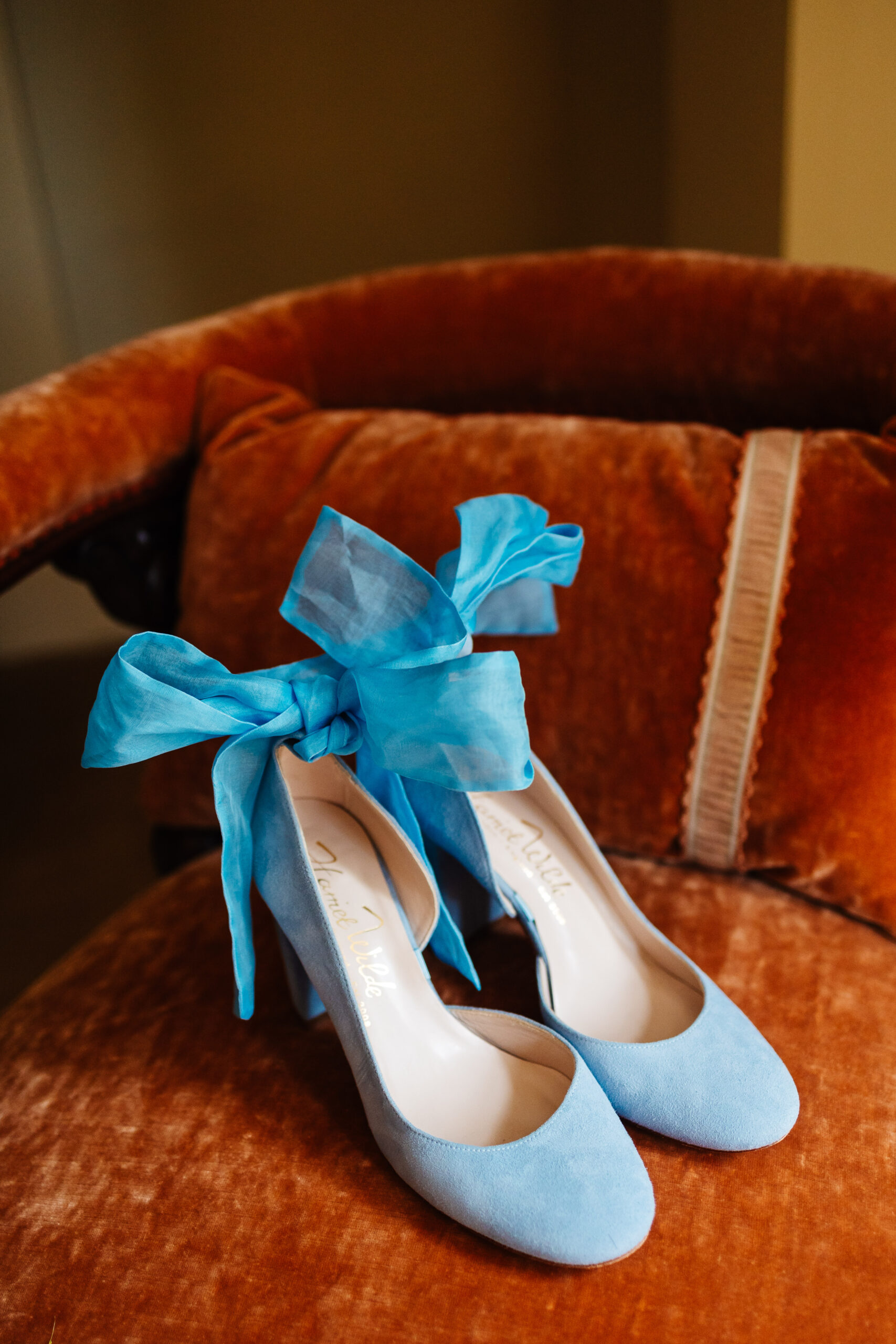 The bride's shoes. They are pale bale suede and have a large blue bow on the heels.