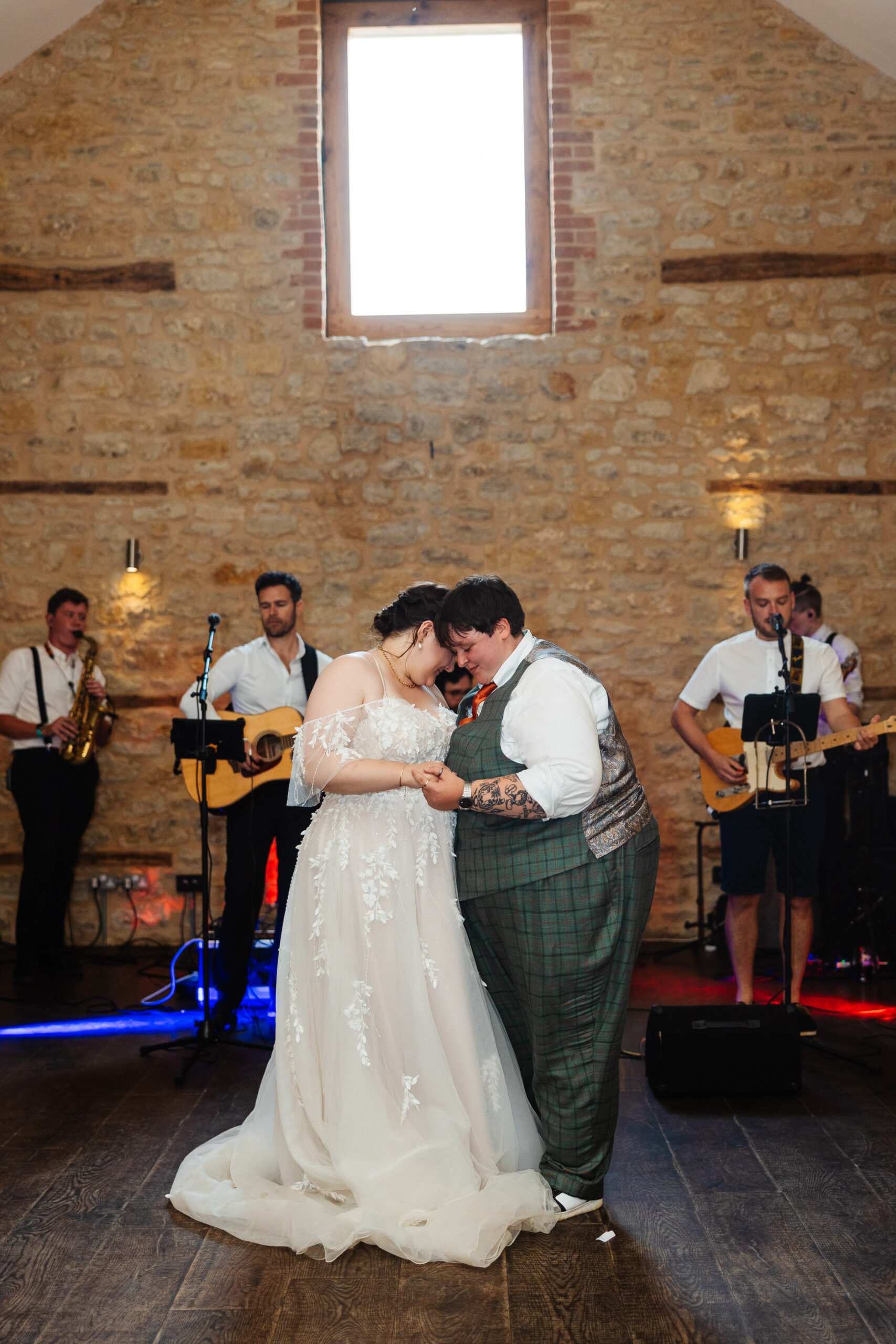 The couple at their first dance. They are holding one another and smiling.