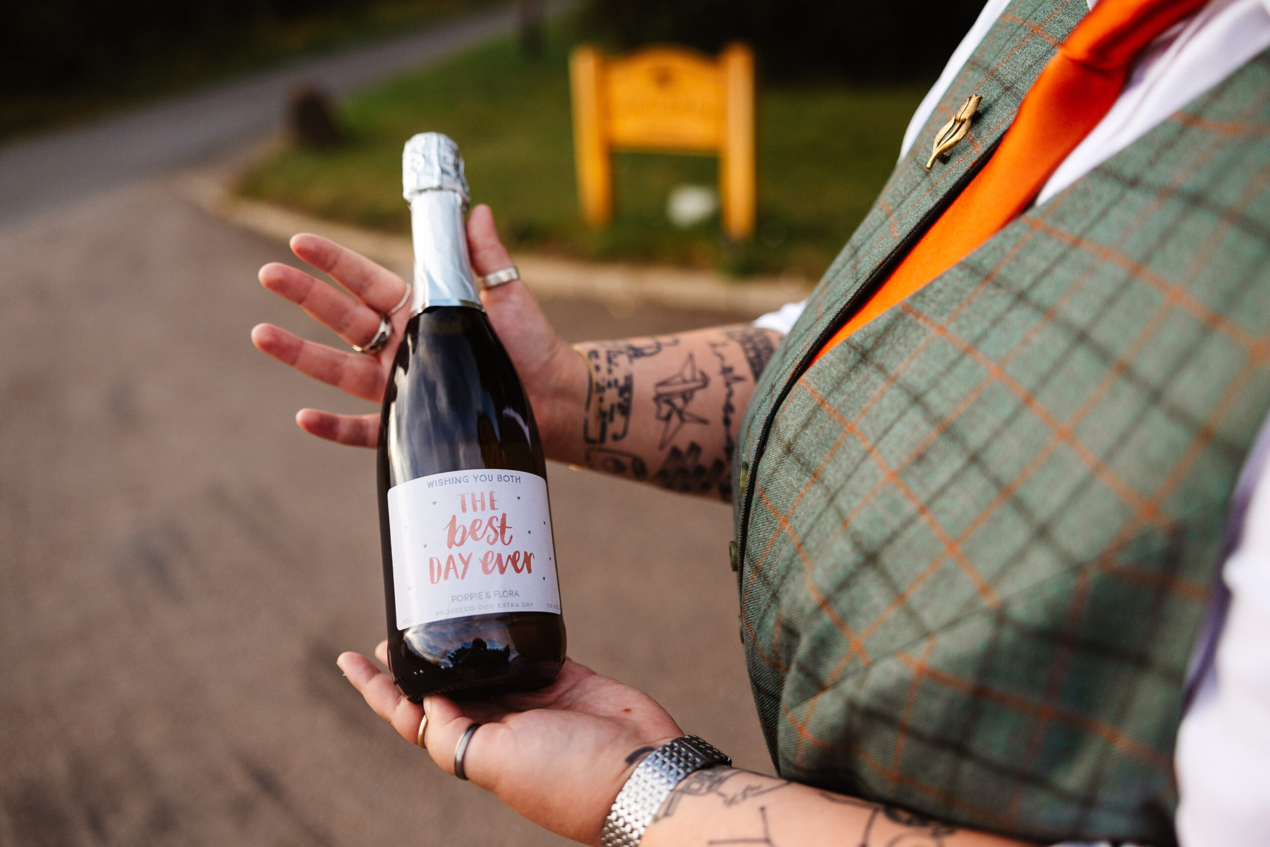 A personalised bottle of prosecco. It has "The best day ever" written on it, as well as the couples name and the date of their wedding.