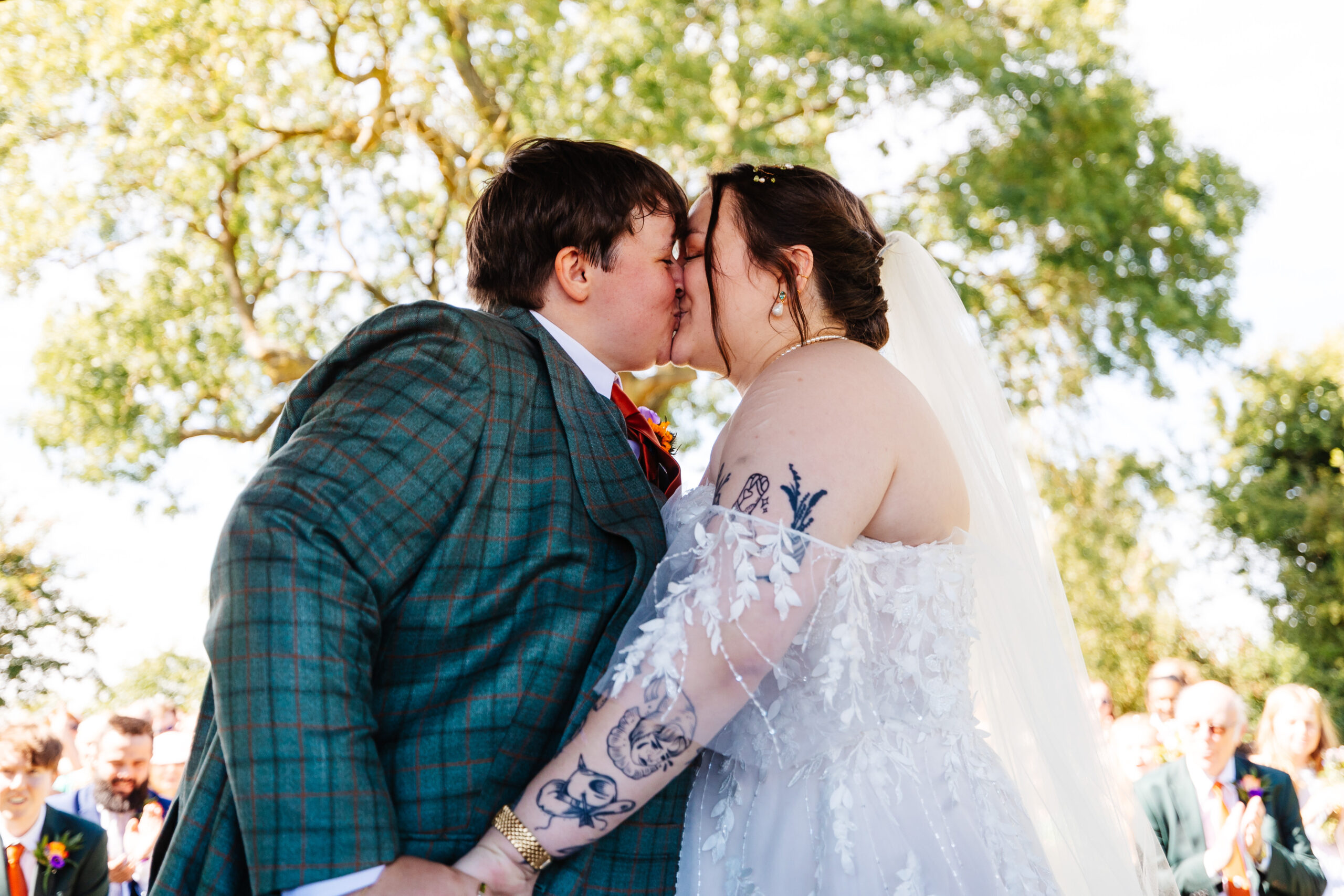 The brides kissing as their marriage is announced.