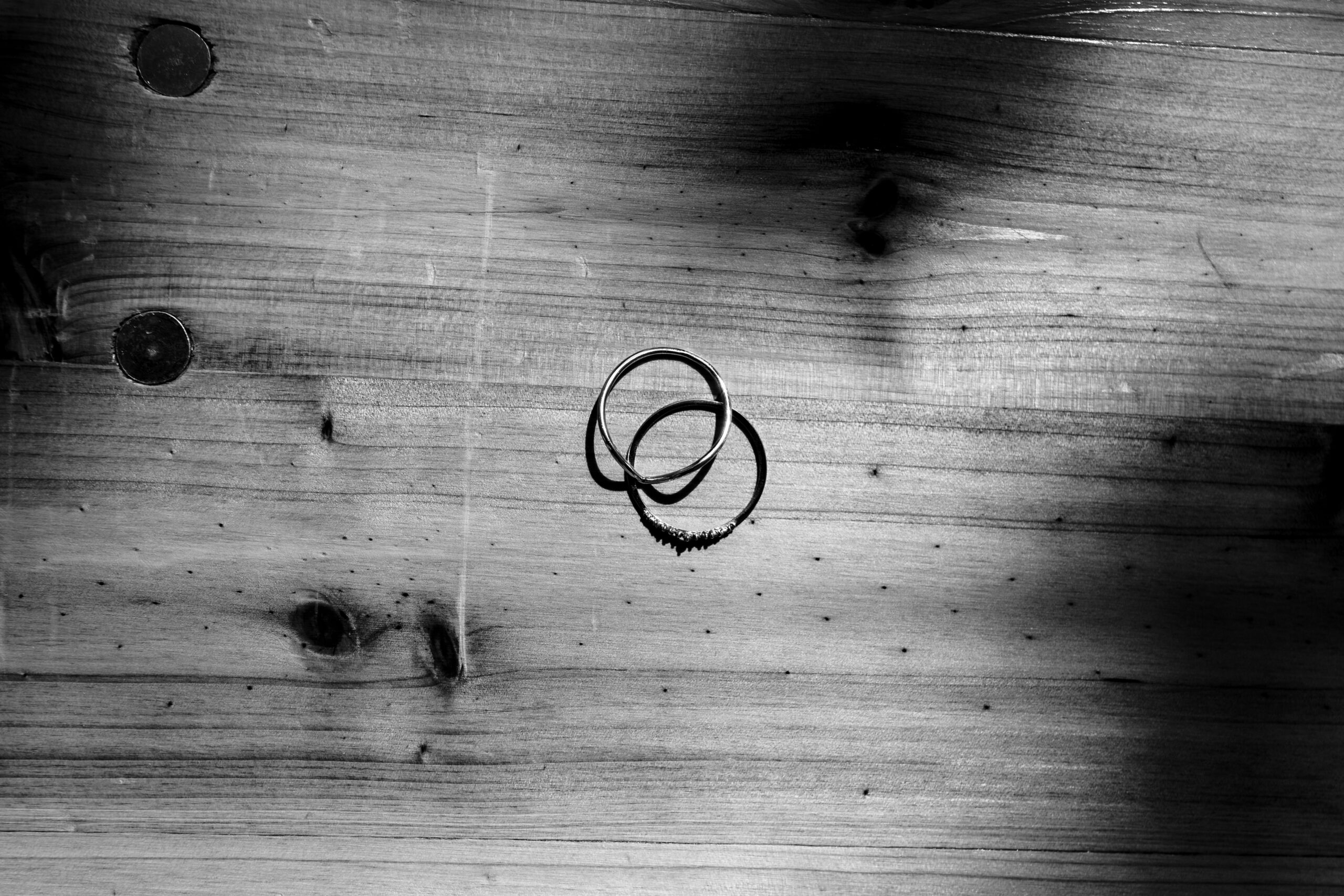 A black and white image of the two rings that the couple will exchange on their wedding day.