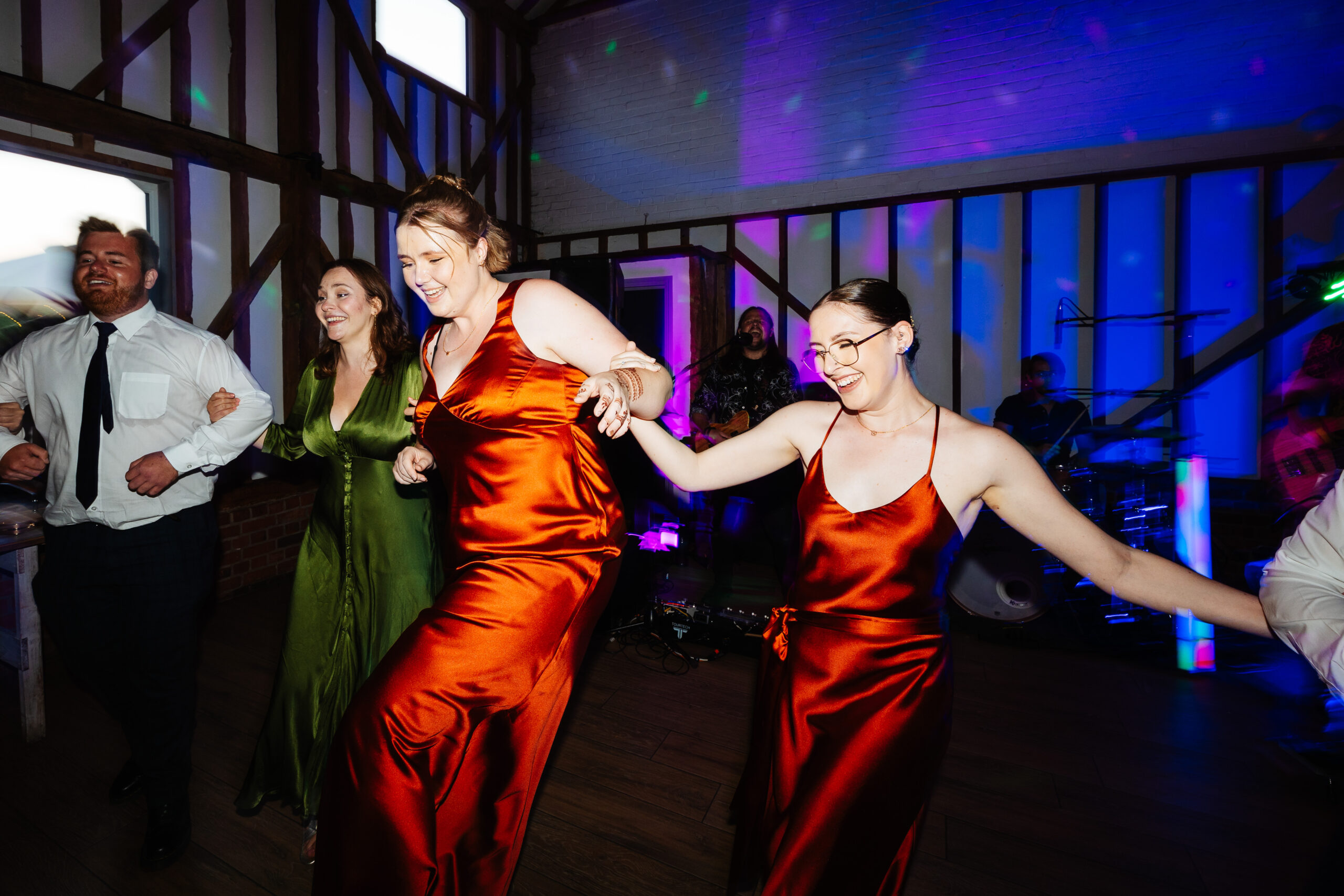 Two bridesmaids dancing on the dance floor having fun!