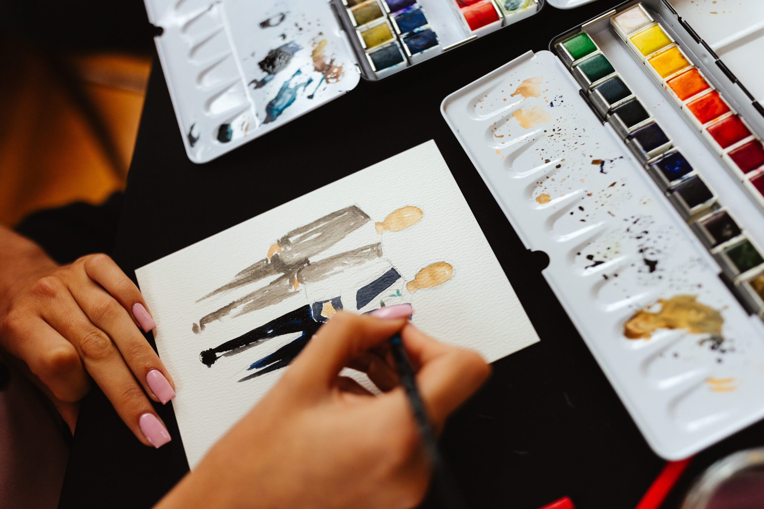 An artist painting a water colour of two guests.