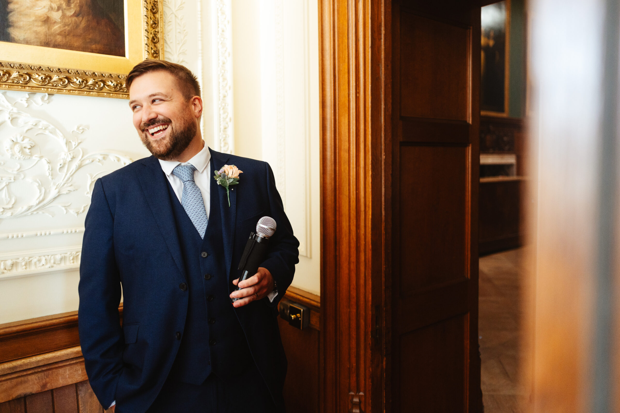 A groomsman holding a microphone about to welcome in the new Mr & Mrs Jay.