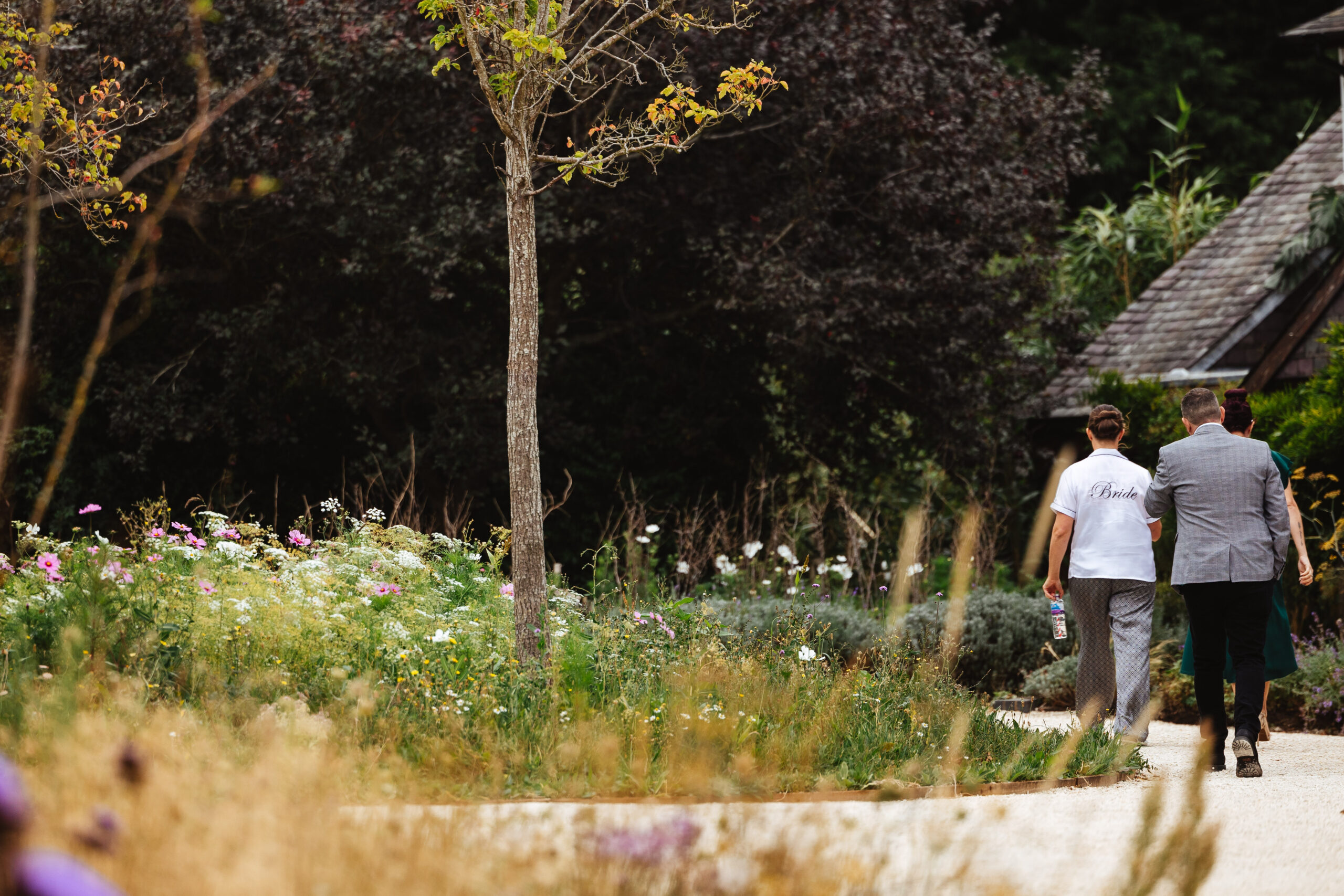 The bride walking around the gardens. She is in pyjama bottoms and a white pyjama top that says Bride on the back.