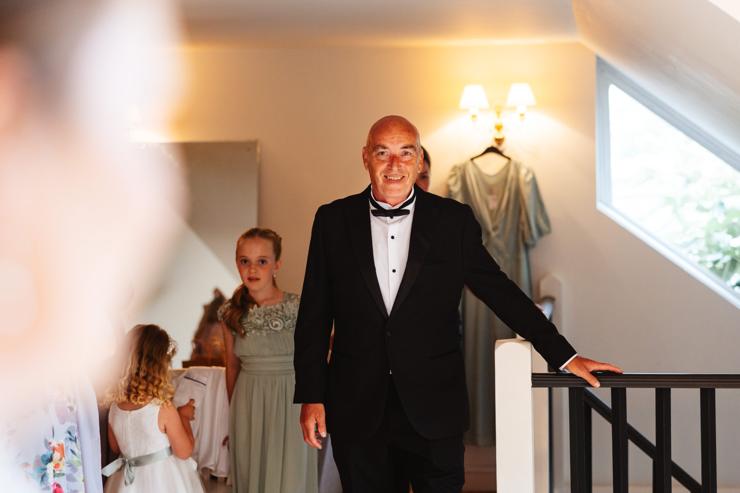 The bride's father walking towards the bride. He is smiling at her and looks so proud.