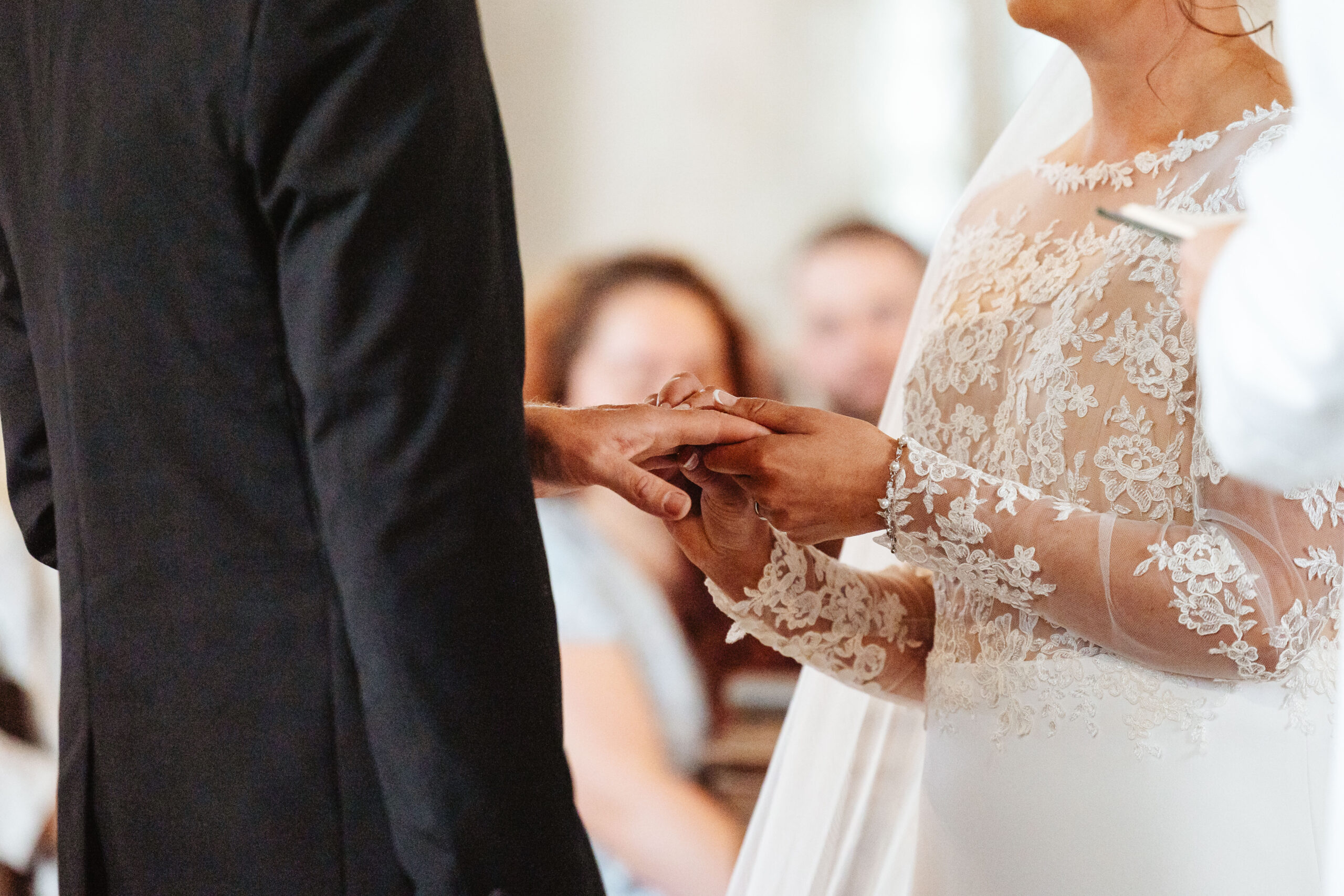 The bride and groom exchanging rings. You can only see their hands.