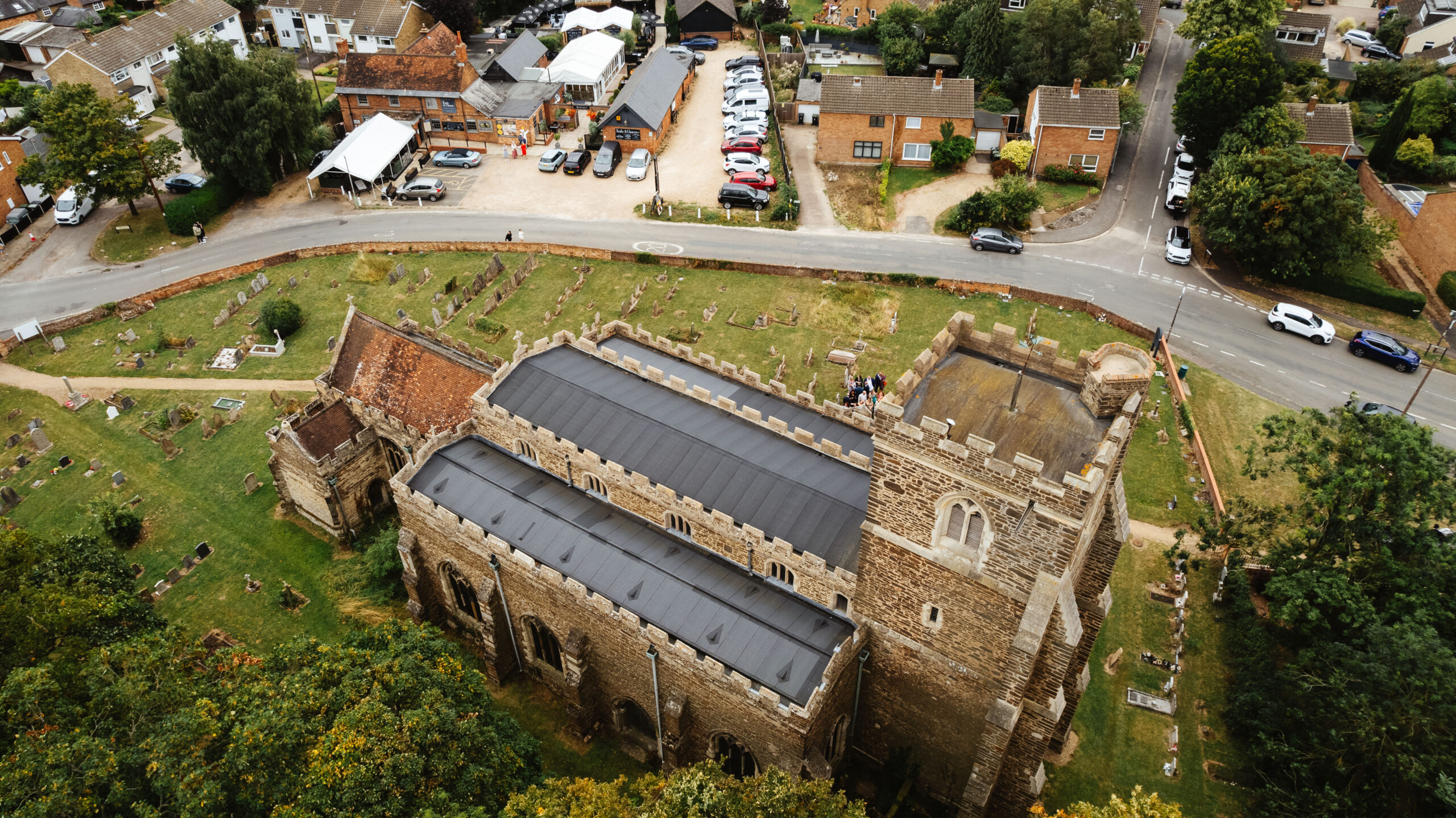 An aerial shot of the church. You can see some of the guests congregating outside of the church.