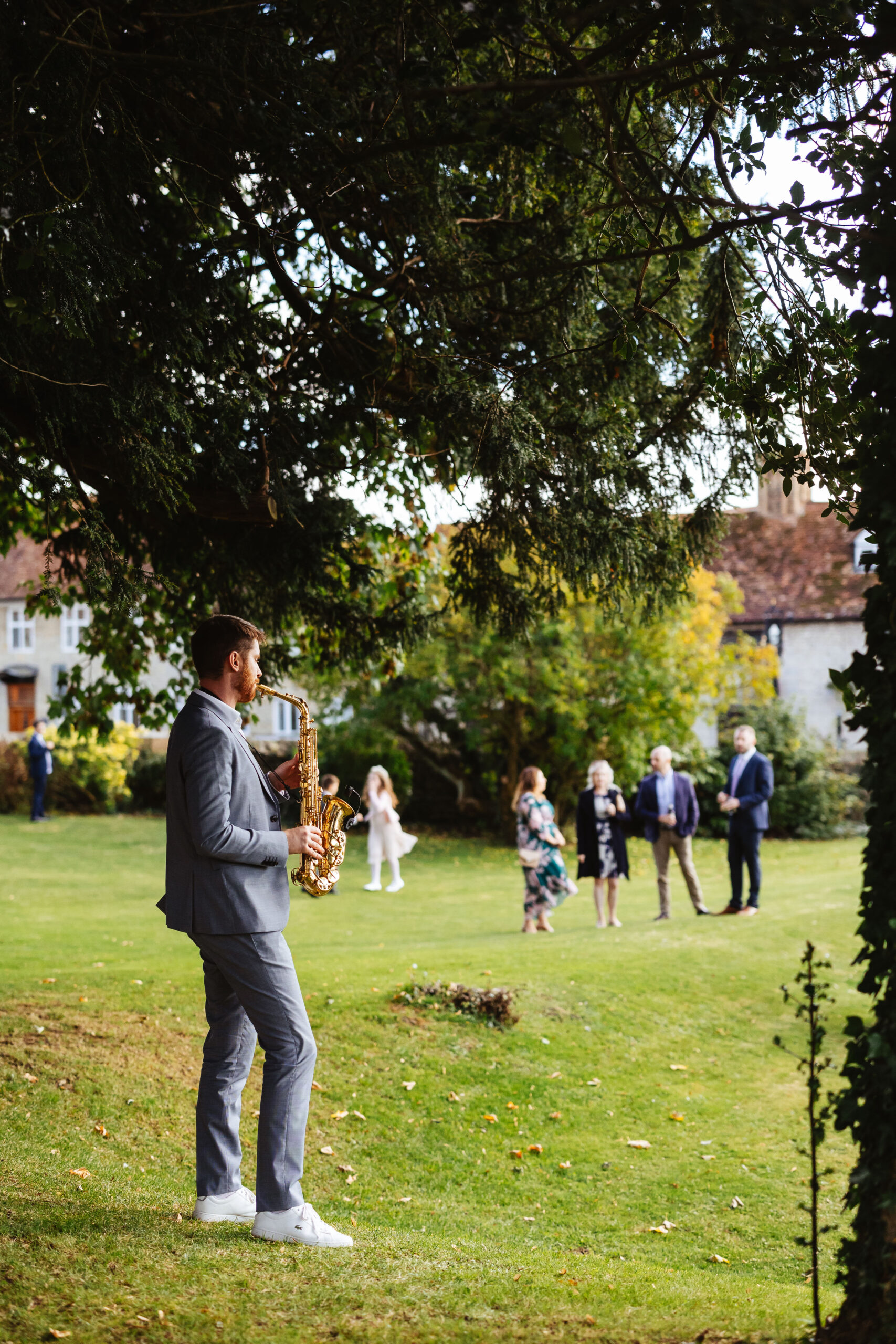 A saxophonist playing his saxophone for the guests.