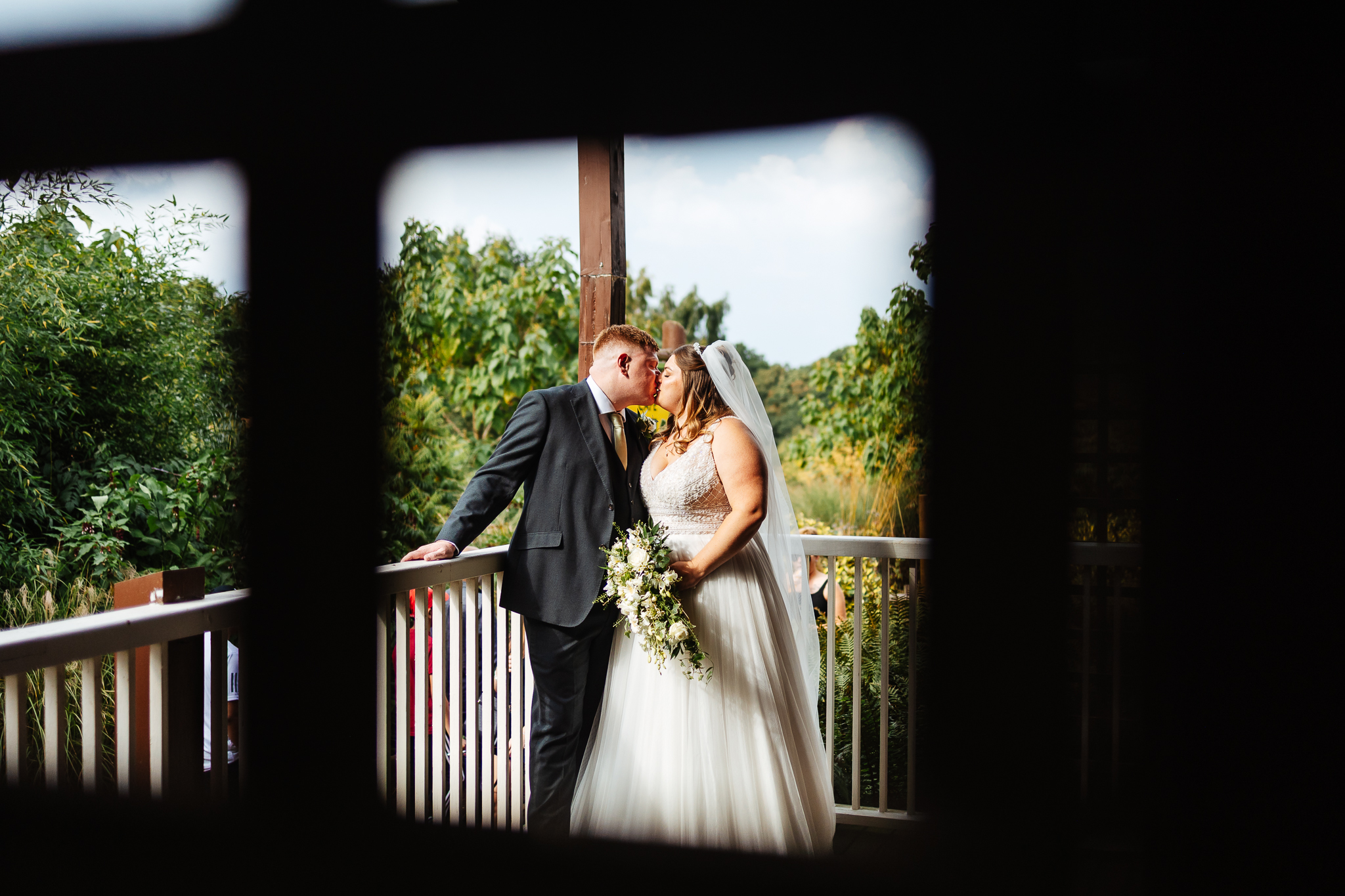 bride and groom on veranda at woburn safari park wedding